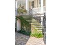 Beautiful stairs leading up to a porch with brick and vine accents at 11 Church St, Charleston, SC 29401