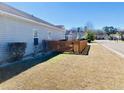 Side yard featuring a well-maintained lawn, complemented by a stylish wooden fence for added privacy at 113 Mayfield Dr, Goose Creek, SC 29445