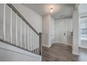 Welcoming entryway with hardwood floors, staircase, and closet space at 131 Summer Tanager Dr, Ravenel, SC 29470
