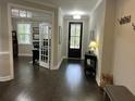 Elegant entryway with hardwood floors and a view into the office through french doors at 1601 Secessionville Rd, Charleston, SC 29412