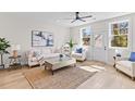 Inviting living room with a jute rug, white sofa, stylish decor, and a ceiling fan for a comfortable atmosphere at 2193 Helm Ave, North Charleston, SC 29405