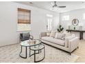 Cozy living room with a comfortable beige sofa, round glass coffee tables, and a stylish area rug at 231 Abercom Place Dr, Moncks Corner, SC 29461