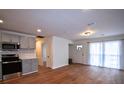 Open living space featuring wood floors, modern kitchen, and natural light at 338 Holly Ave, Goose Creek, SC 29445