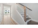 Elegant staircase with wood and white painted accents, leading to the upper level at 349 Chapman Cir, Goose Creek, SC 29445
