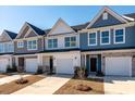 Attractive townhome exteriors feature attached garages, manicured landscaping, and eye-catching color palettes at 404 Duskywing Dr, Goose Creek, SC 29445
