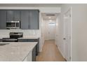 Modern kitchen features grey cabinets, stainless steel appliances, granite countertops and white subway tile backsplash at 404 Duskywing Dr, Goose Creek, SC 29445