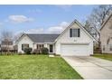 Traditional home showcasing a well-kept lawn, black shutters, and an attached two-car garage at 412 Hainesworth Dr, Charleston, SC 29414