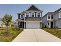 Charming two-story home with navy siding, white trim, and a spacious two-car garage at 418 Grove End Rd, Moncks Corner, SC 29461