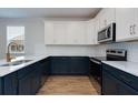Modern kitchen with two-tone cabinets, stainless steel appliances, and marble countertops at 418 Grove End Rd, Moncks Corner, SC 29461