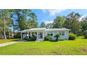 Cozy single-story home with a carport, complemented by a lush green lawn and mature trees at 422 Academy Rd, Walterboro, SC 29488