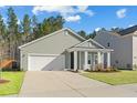 A well-maintained home with a two-car garage and a cozy front porch at 4316 Cotton Flat Rd, Summerville, SC 29485