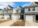 Attractive townhome row boasting varied siding, garages, and fresh landscaping at 447 Duskywing Dr, Goose Creek, SC 29445