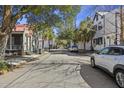 Quiet, tree-lined street showcasing charming homes, perfect for serene living and picturesque neighborhood strolls at 45 Bogard St, Charleston, SC 29403