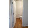 Powder room with hardwood floors, toilet, and white walls, providing a clean and functional space at 5208 Fernland Way, North Charleston, SC 29420