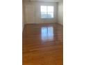 Well-lit living room with hardwood floors and a bright window, creating a warm and welcoming atmosphere at 5208 Fernland Way, North Charleston, SC 29420