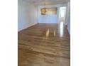 Open-concept living space with gleaming hardwood floors, perfect for entertaining and Gathering gatherings at 5208 Fernland Way, North Charleston, SC 29420