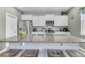 Well-designed kitchen featuring a large island with counter seating, granite countertops, and stainless steel appliances at 543 Wayton Cir, Moncks Corner, SC 29461