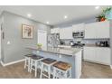 Modern kitchen featuring white cabinets, stainless steel appliances, granite countertops, and a spacious island at 543 Wayton Cir, Moncks Corner, SC 29461