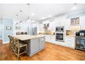 Bright, spacious kitchen with white cabinetry, stainless steel appliances, and granite countertops at 734 Canopy Cove Cv, Charleston, SC 29412