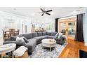 Cozy living room featuring a large sectional sofa, area rug, ceiling fan, and access to the screened porch at 734 Canopy Cove Cv, Charleston, SC 29412