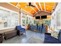 Inviting screened porch with bar, TV, and comfortable seating, perfect for entertaining at 734 Canopy Cove Cv, Charleston, SC 29412