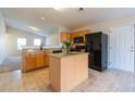 Open concept kitchen with island, granite counters, and black appliances, perfect for entertaining at 7919 New Ryder Rd, North Charleston, SC 29406