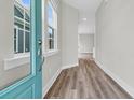 Bright entryway featuring wood-look floors, a blue front door, and ample natural light at 810 Gentle Breeze Dr, Summerville, SC 29486