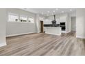 Open-concept living space showcasing wood-look floors and a modern kitchen with white cabinets at 810 Gentle Breeze Dr, Summerville, SC 29486