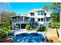 Backyard oasis with private pool, lounge chairs, and a screened porch offering relaxation and entertainment at 886 White Point Blvd, Charleston, SC 29412