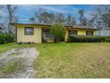 Inviting single-story home featuring a spacious yard and convenient gravel driveway at 1024 Locksley Dr, Charleston, SC 29407