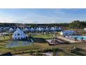 Aerial view of a new construction neighborhood with a pool, playground, and common areas at 1058 Marsh Harrier Dr # 15-7P, Ravenel, SC 29470