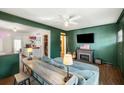 Cozy living room with stylish green walls, fireplace, and a view into the modern kitchen area at 1195 Marquis Rd, North Charleston, SC 29405