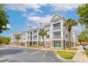 Well-maintained apartment complex featuring multiple balconies, palm trees, and ample parking at 130 River Landing Dr # 7309, Charleston, SC 29492