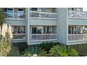 Coastal condo building featuring private balconies and lush landscaping at 1300 Ocean Blvd # 102 A, Isle of Palms, SC 29451
