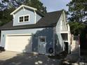 Exterior view of carriage house above a garage with steps leading to a landing and a balcony at 1328 Erckmann Dr, Mount Pleasant, SC 29464