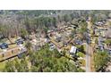 Wide aerial view of a residential area with many homes surrounded by mature trees and well-kept lawns at 144 Cinnamon Rd, Summerville, SC 29483
