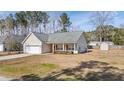 Attractive one-story home with a well-maintained lawn, attached garage and a convenient storage shed at 144 Cinnamon Rd, Summerville, SC 29483
