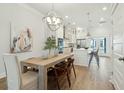 Bright dining area flows into a modern kitchen with a stylish wooden table and contemporary lighting at 1515 Hidalgo Dr, Mount Pleasant, SC 29464