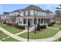 Beautiful home featuring a spacious porch, complemented by manicured landscaping and a street view at 1556 Cranes Nest Rd, Mount Pleasant, SC 29466