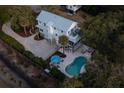 Aerial view of a coastal home featuring a pool, patio, and lush landscaping at 1648 Home Farm Rd, Mount Pleasant, SC 29464