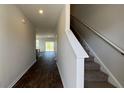 Inviting entryway with wood-look floors and staircase, leading to a bright, open living space at 210 Blue Haw Dr, Moncks Corner, SC 29461