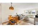 Cozy living room featuring a comfortable couch, dining set, and a large window offering scenic views of nature at 2119 Landfall Way, Seabrook Island, SC 29455