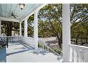 Inviting balcony view with classic white columns, offering outdoor space and a charming neighborhood view at 214 Calhoun St # 5, Charleston, SC 29401