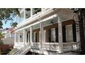 Detailed view of the home's exterior, highlighting the balconies with white columns and black shutters at 214 Calhoun St # 5, Charleston, SC 29401