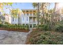 Beautiful home with double porches, a walkway, mature landscaping and trees at 26 Saturday Rd, Mount Pleasant, SC 29464