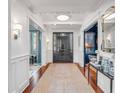 Grand foyer with hardwood floors, wainscoting, statement lighting, and views into other rooms at 309 N Civitas St, Mount Pleasant, SC 29464