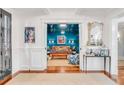 Elegant entry into a stylish living room featuring a large window, hardwood floors, and fine furnishings at 309 N Civitas St, Mount Pleasant, SC 29464
