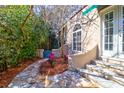 Backyard stone patio featuring lush foliage, privacy landscaping and access steps at 339 Cabell St, Charleston, SC 29407