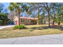 Lovely home featuring a red tile roof, well-kept lawn, and convenient garage access at 339 Cabell St, Charleston, SC 29407