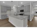 Modern kitchen features gray cabinets, a spacious island, stainless steel appliances and sleek backsplash at 642 Cottage Landing Dr, Summerville, SC 29485